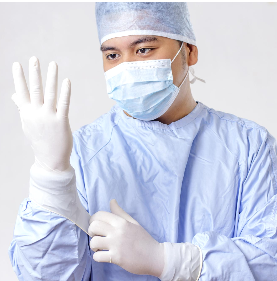 Stock photo of medical practitioner putting on gloves.